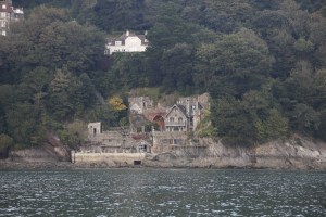 A chap has been building this house among the rock face along the river from Kingswear of about 20 years. He has even built his own tracks to transport building materials etc up & down the steep cliff side