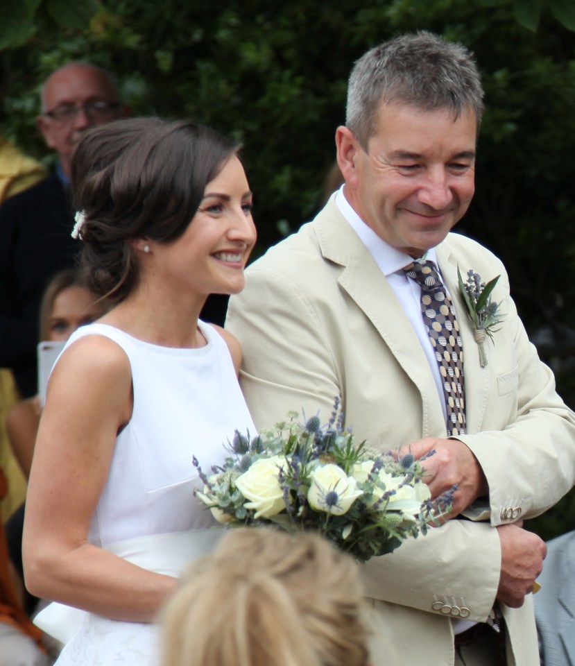 Bob proudly walking Hazel down to the wedding arch